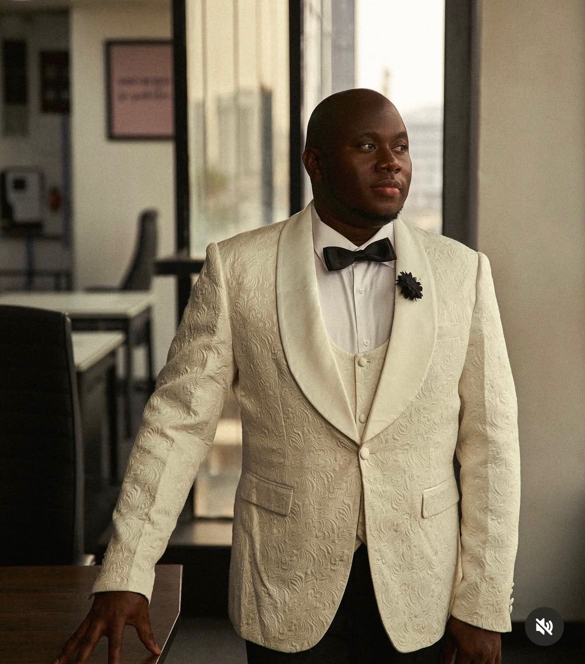Qasim Abiola Oderinde in a white jacquard tuxedo